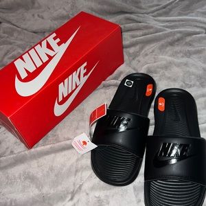 All black Nike slides